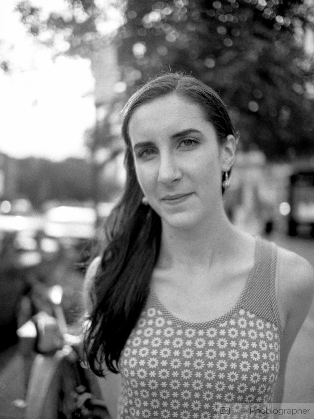 Photographers Love Their Tones. But This Makes Them Useless Black-and-white photo of a woman with long hair, wearing a sleeveless floral top, standing outdoors.