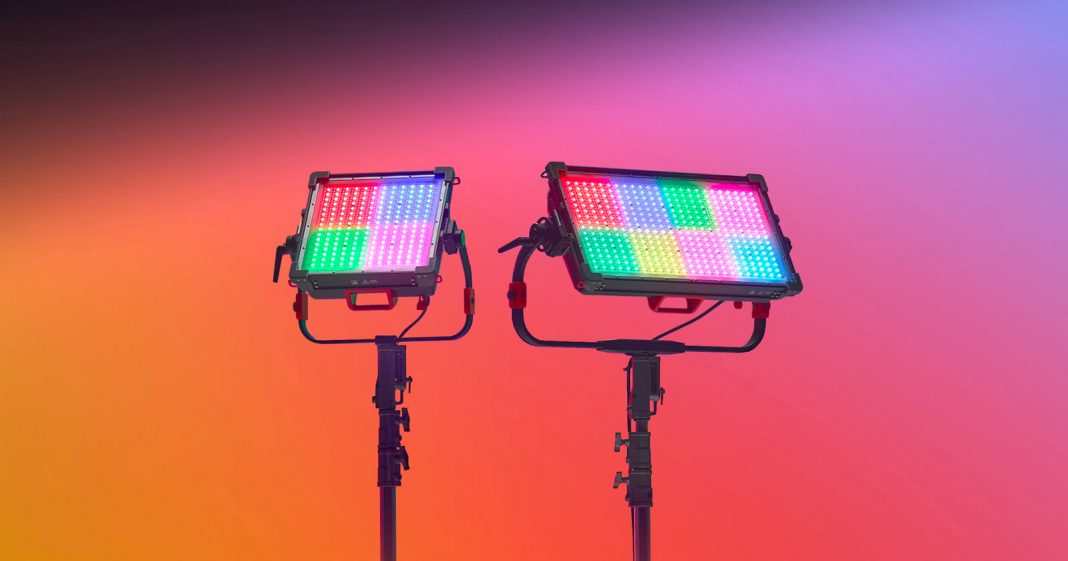 Godox's New LEDs Are Colorful, Powerful, and Weather Resistant Two professional LED panel lights on stands emit multicolored light patterns against a vibrant gradient background of orange, pink, and purple hues.