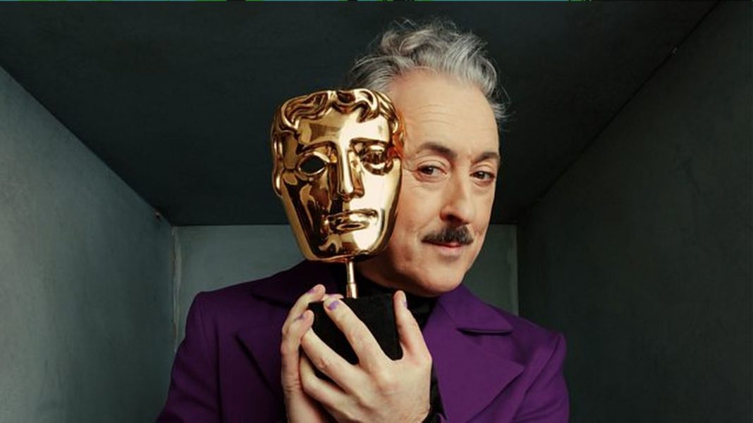 Host Alan Cumming clutches an award in a promotional image for the BAFTAs 2026