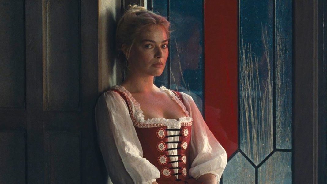 Margot Robbie sitting next to a window in Wuthering Heights